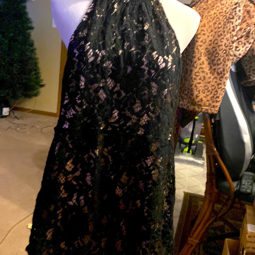 This is a beautiful black crocheted jumpsuit with tan lining it is a size small
